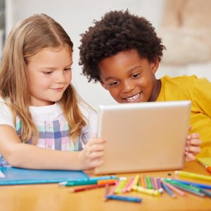 Shot of two preschool students looking at something on a digital tablet together Harnessing the Strength of Afrocentric Values with Global Education Standards