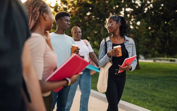 Diverse group of exchange students walking at campus and chatting. Cultural Pride Meets Academic Excellence at Freedom International Schools-Africa